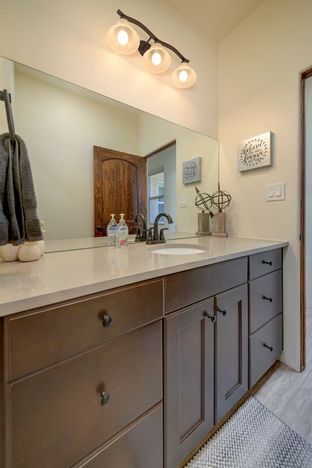 bathroom with vanity and hardwood / wood-style floors