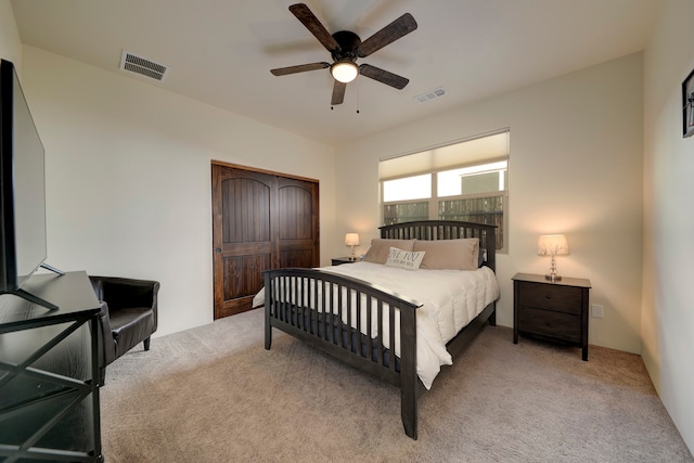 bedroom with light carpet, a closet, and ceiling fan