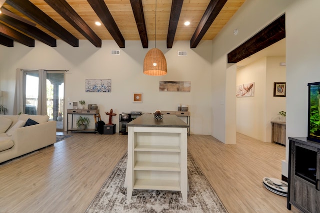 kitchen with wood ceiling, beamed ceiling, light hardwood / wood-style flooring, and hanging light fixtures