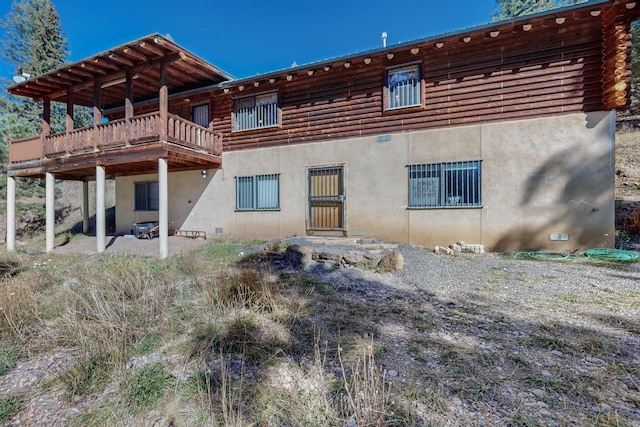 12 Pine Ln, Terrero, NM 87573 - back of house with stucco siding, log siding, and a wooden deck