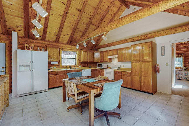12 Pine Ln, Terrero, NM 87573 - kitchen with white appliances, high vaulted ceiling, wooden ceiling with exposed beams, brown cabinets, and under cabinet range hood