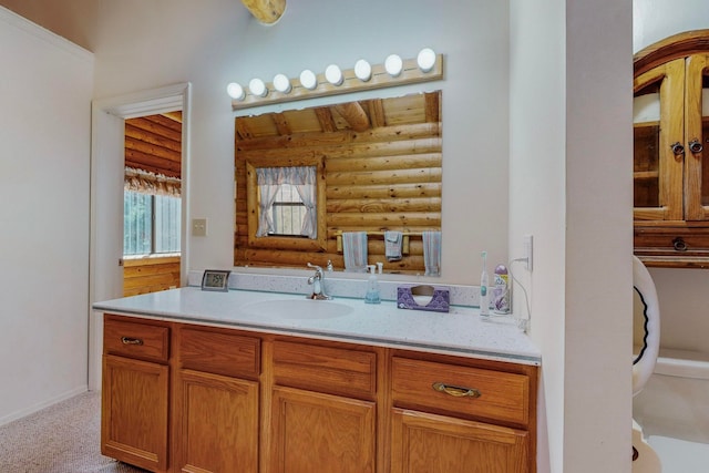 bathroom featuring vanity and rustic walls