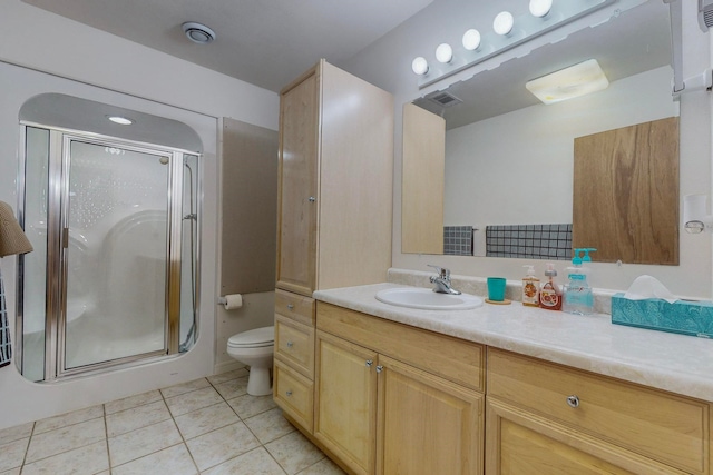 bathroom featuring vanity, a shower with shower door, toilet, and tile patterned flooring