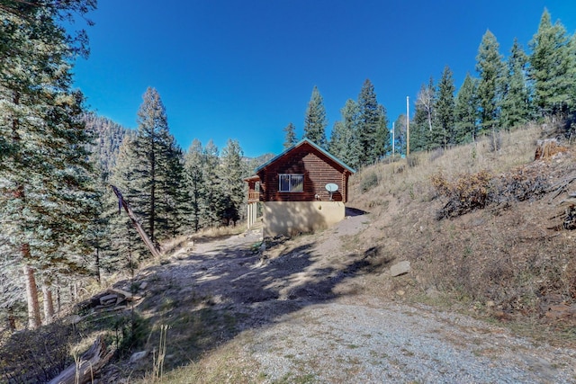 12 Pine Ln, Terrero, NM 87573 - view of home's exterior featuring log siding