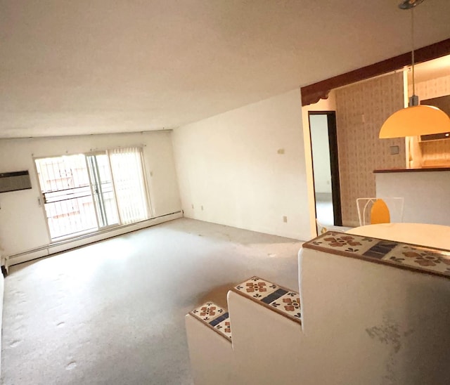 unfurnished living room with vaulted ceiling and a baseboard heating unit