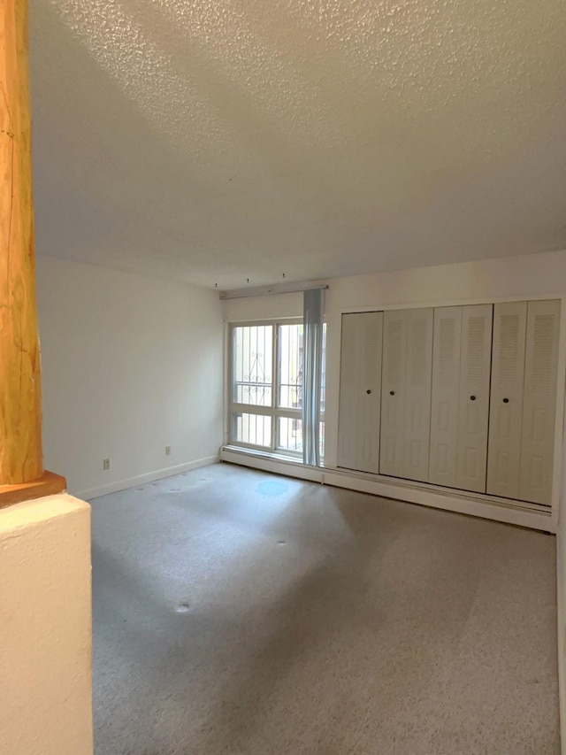 interior space with baseboard heating and a textured ceiling