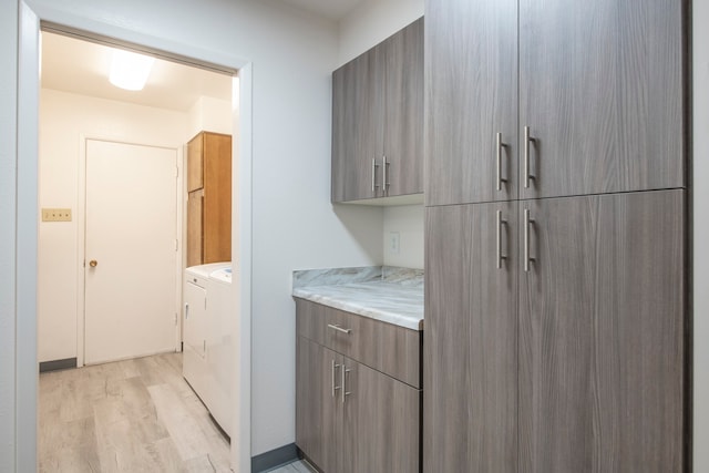 washroom with cabinets and light wood-type flooring