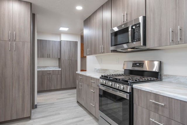 kitchen with stainless steel appliances and light wood-type flooring