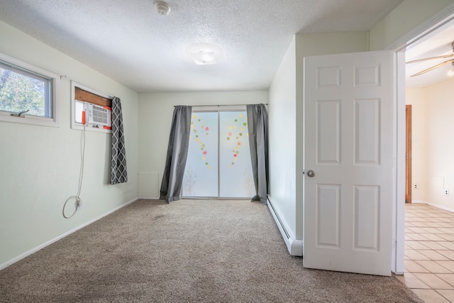 carpeted spare room with a textured ceiling and baseboard heating