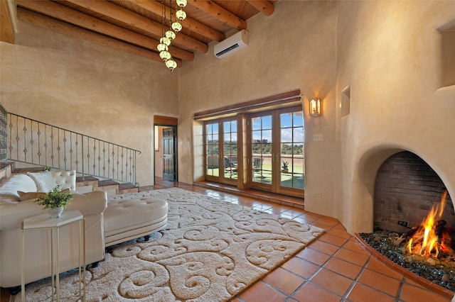 living room with a towering ceiling, a wall mounted air conditioner, tile patterned flooring, wood ceiling, and beam ceiling