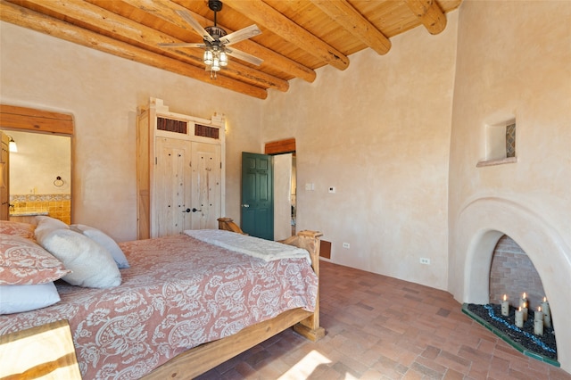 bedroom with ceiling fan, wooden ceiling, and beamed ceiling