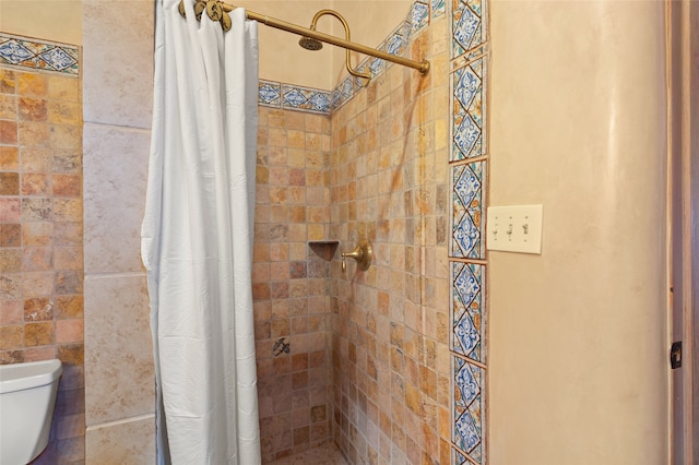 bathroom featuring toilet and walk in shower