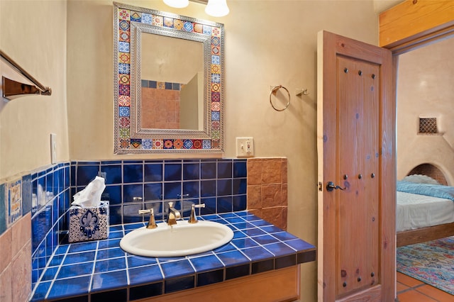 bathroom with tile patterned floors, vanity, and backsplash