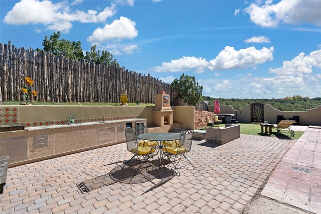 view of patio / terrace with a multi sided fireplace