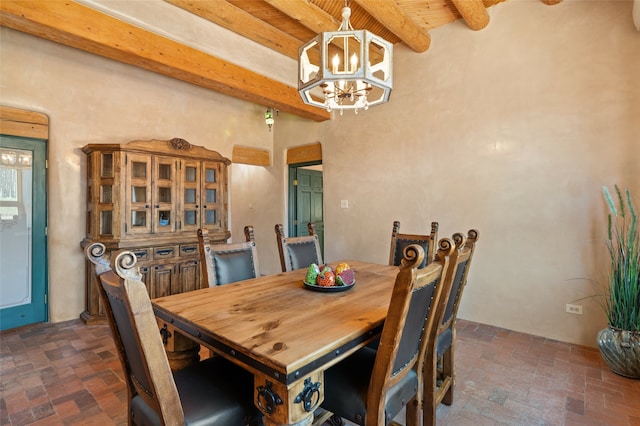 dining room with beamed ceiling, wooden ceiling, and an inviting chandelier