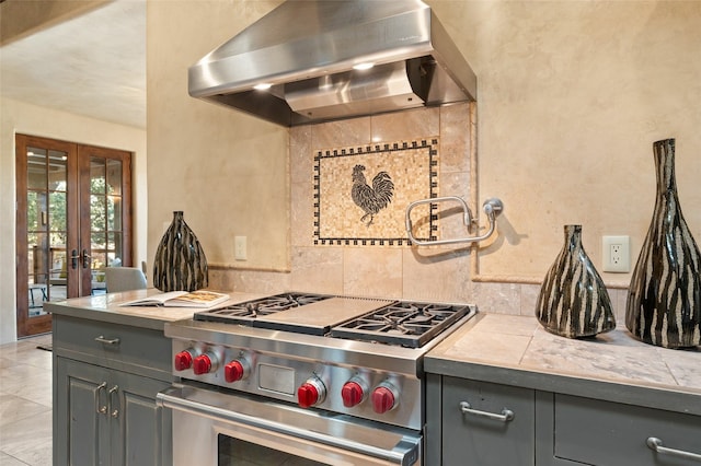 kitchen with french doors, extractor fan, tile countertops, stainless steel range, and gray cabinetry