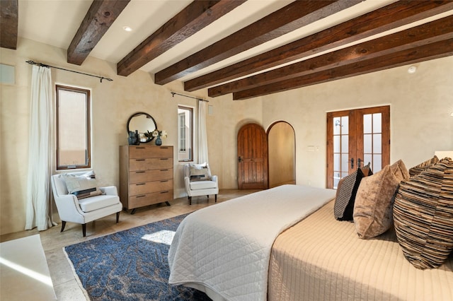 bedroom featuring multiple windows, french doors, and beamed ceiling