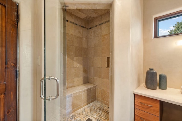 bathroom with vanity and a shower with shower door