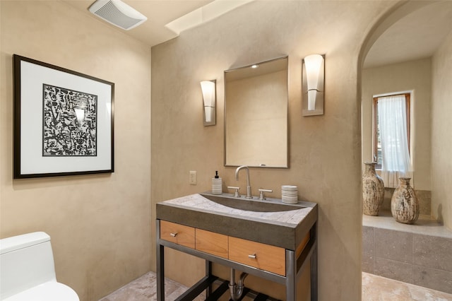 bathroom with vanity and toilet