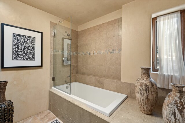 bathroom featuring tiled shower / bath combo and tile patterned floors