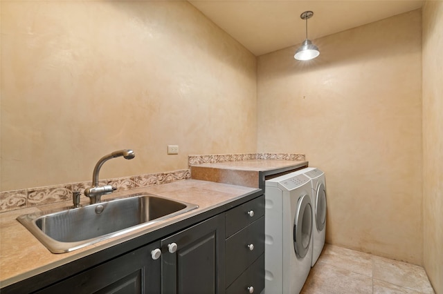 laundry area featuring sink, independent washer and dryer, cabinets, and light tile patterned floors