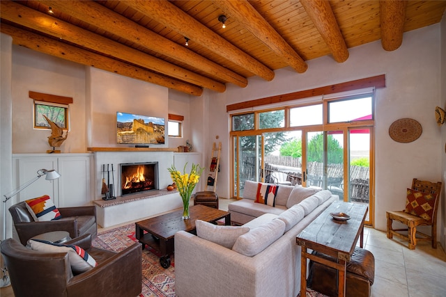 living room featuring beam ceiling, light tile patterned flooring, and wood ceiling