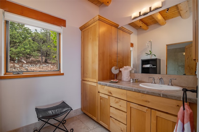 bathroom with a shower with door, wood ceiling, tile patterned floors, vanity, and beam ceiling