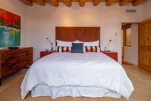 carpeted bedroom with beamed ceiling