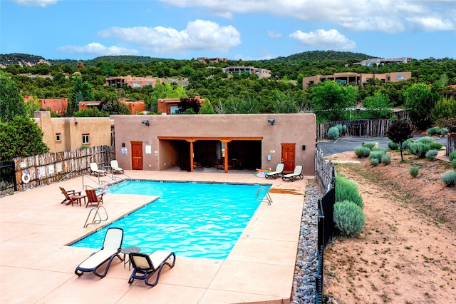 view of swimming pool with a patio area