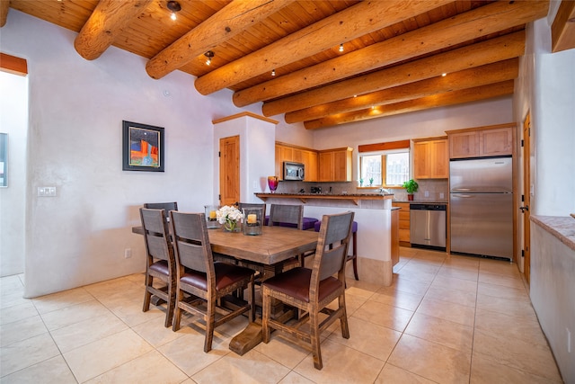 tiled dining room featuring beam ceiling and wood ceiling