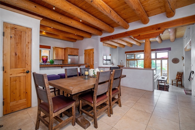 tiled dining space featuring wood ceiling and beamed ceiling