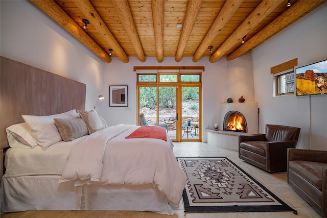 tiled bedroom featuring beam ceiling, wood ceiling, access to exterior, and a large fireplace