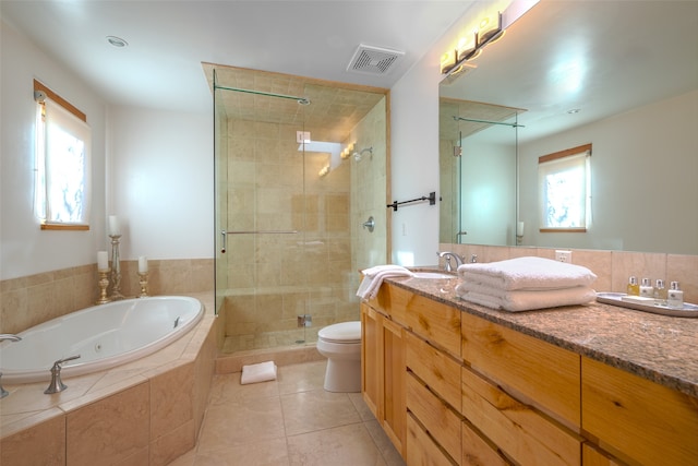 full bathroom featuring vanity, toilet, independent shower and bath, and a wealth of natural light