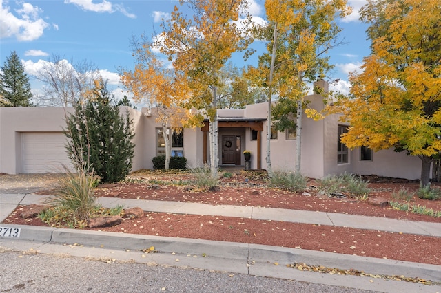 pueblo-style home featuring a garage