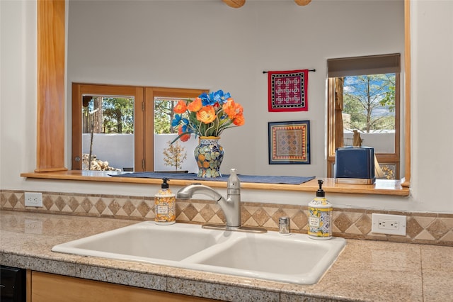 room details featuring sink and black dishwasher