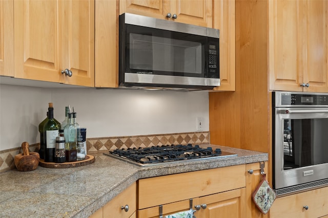 kitchen featuring light brown cabinetry and stainless steel appliances