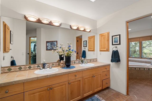 bathroom with vanity, tiled bath, and tile patterned floors