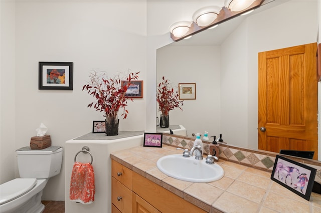 bathroom featuring toilet and vanity