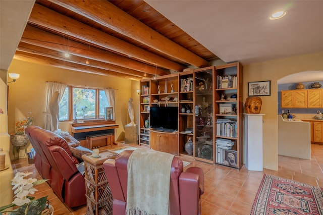 living room featuring beam ceiling, light tile patterned flooring, and wood ceiling