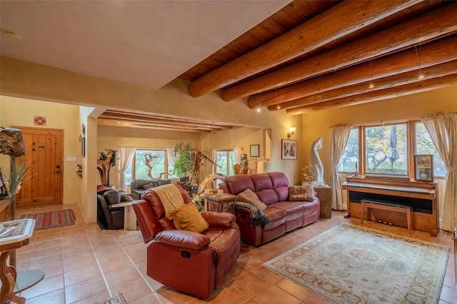 living room with beamed ceiling, light tile patterned floors, and wooden ceiling