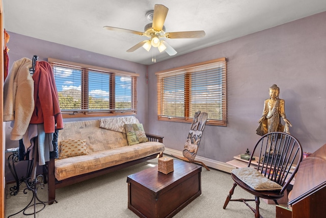 living area with baseboards, carpet flooring, and ceiling fan