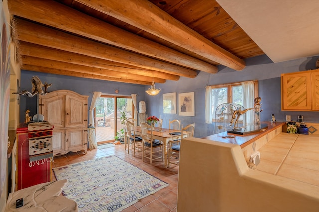 kitchen featuring pendant lighting, light brown cabinets, wooden ceiling, light tile patterned floors, and beam ceiling