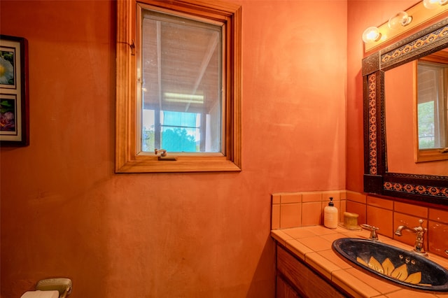 bathroom with tasteful backsplash and vanity