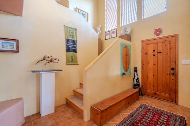 foyer featuring a towering ceiling