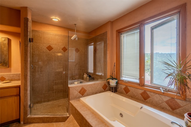 bathroom with tile patterned floors, vanity, and plus walk in shower