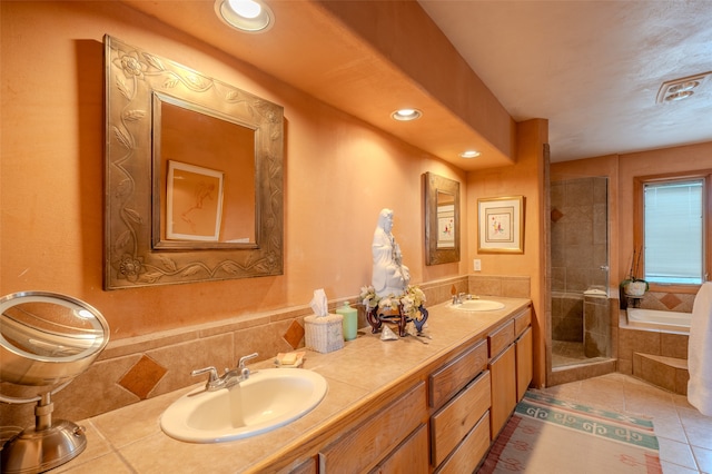 bathroom featuring tile patterned floors, vanity, and separate shower and tub