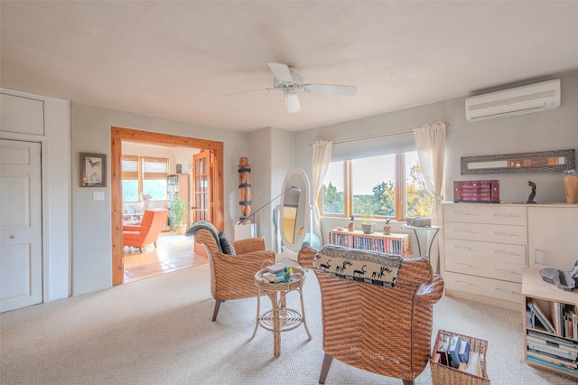 sitting room featuring a wall mounted air conditioner, carpet flooring, and ceiling fan