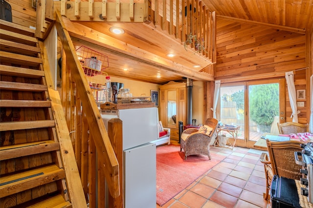 interior space with wooden walls, high vaulted ceiling, and wood ceiling