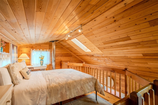 bedroom with lofted ceiling with skylight, wood walls, wooden ceiling, and track lighting