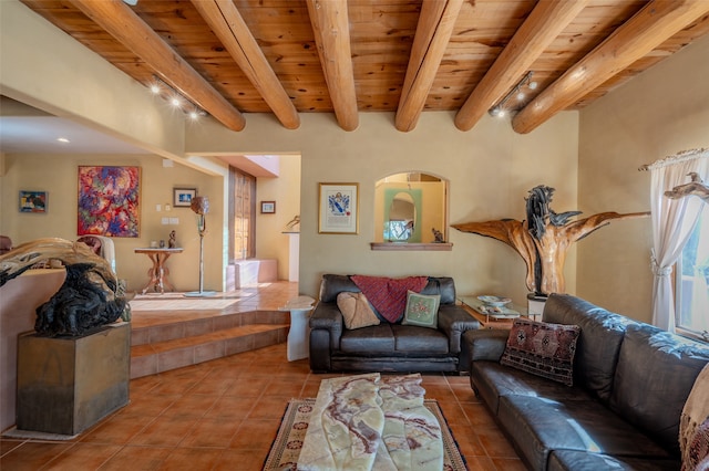 tiled living room with beam ceiling, a healthy amount of sunlight, wooden ceiling, and track lighting